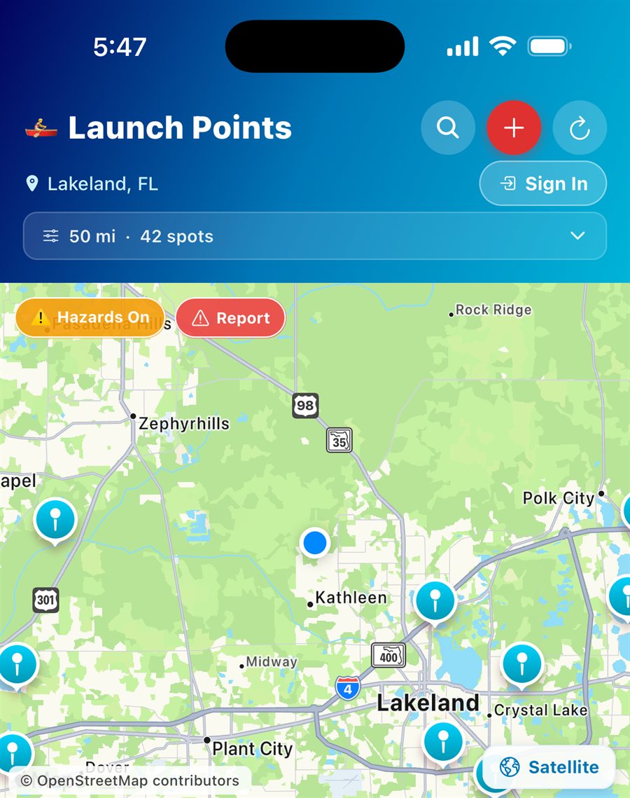 The PaddleReady Launch Points screen: 50 mi / 42 spots near Lakeland, FL, with launch pins on the map, the Hazards On and Report buttons, a Satellite toggle, and OpenStreetMap attribution.